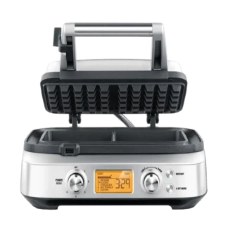 Gofrownica SAGE Smart Waffle SWM620 z otwartą pokrywą, gotowa do pieczenia gofrów. Urządzenie posiada cyfrowy wyświetlacz i pokrętła do ustawiania stopnia wypieczenia oraz wyboru rodzaju gofrów. Elegancka obudowa w srebrnym kolorze, wykonana ze stali nierdzewnej.
